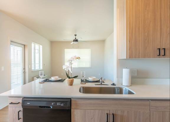 A modern kitchen with a dishwasher and sink at Westgate Apartment Homes, Pendleton, OR