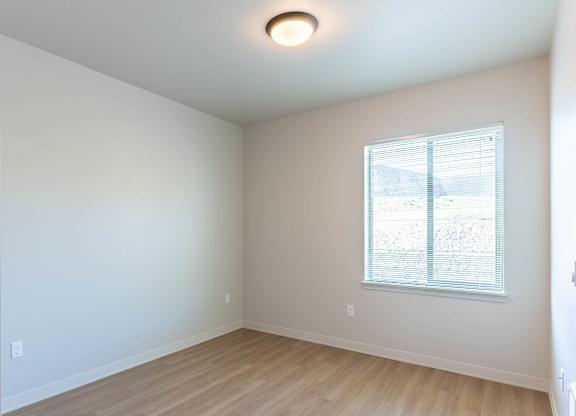 A room with a window and wooden flooring at Westgate Apartment Homes, Pendleton, OR, 97801