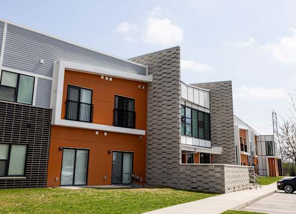 A modern building with orange and grey exterior.