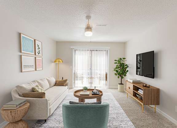A living room with a couch, chair, and television.