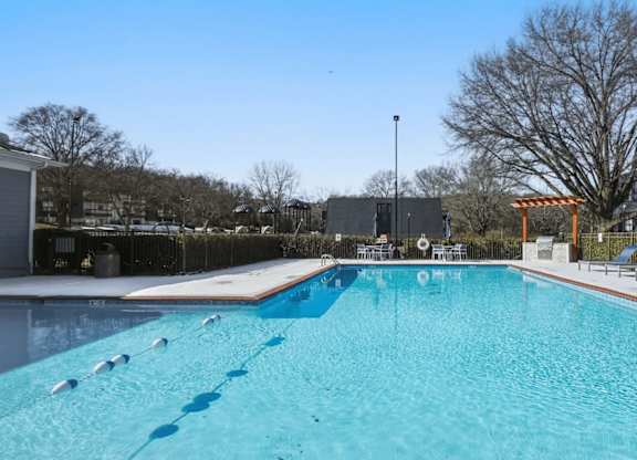 A large swimming pool with a blue tinted water.