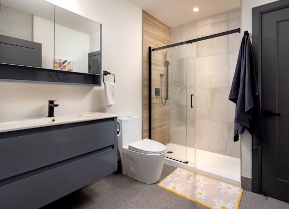 Modern bathroom featuring walk-in shower and floating vanity at Damask, Windsor Ontario