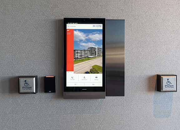 A wall-mounted device displays a weather forecast on its screen at Damask, Windsor, ON
