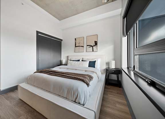 A bedroom with a large bed and a window at Damask, Ontario