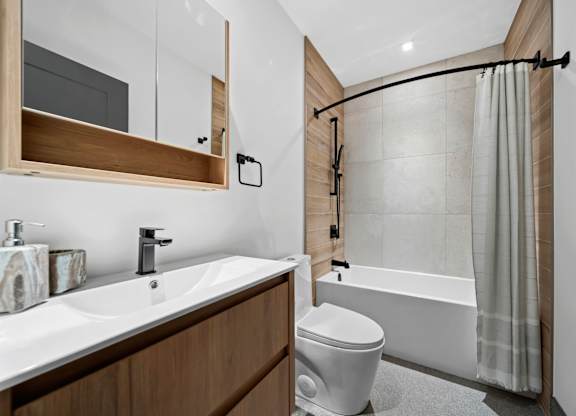 A modern bathroom with a white sink and a white toilet at Damask, Windsor