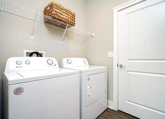 A white washing machine and dryer in a small laundry room.