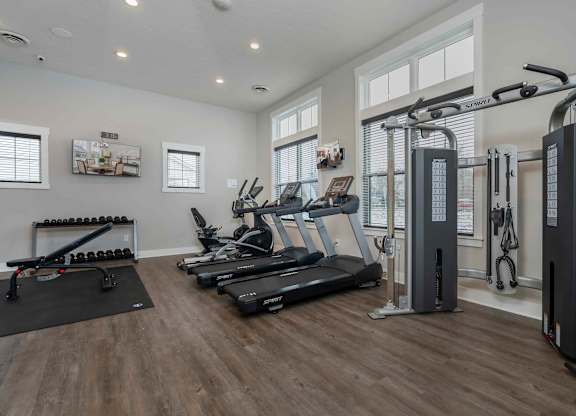 A spacious home gym with a variety of exercise equipment.