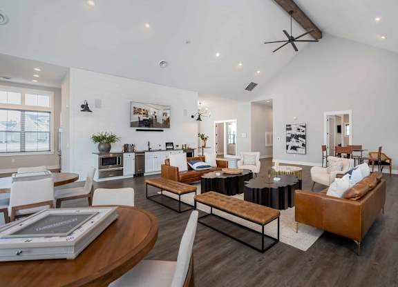A modern living room with a brown leather couch and a wooden coffee table.