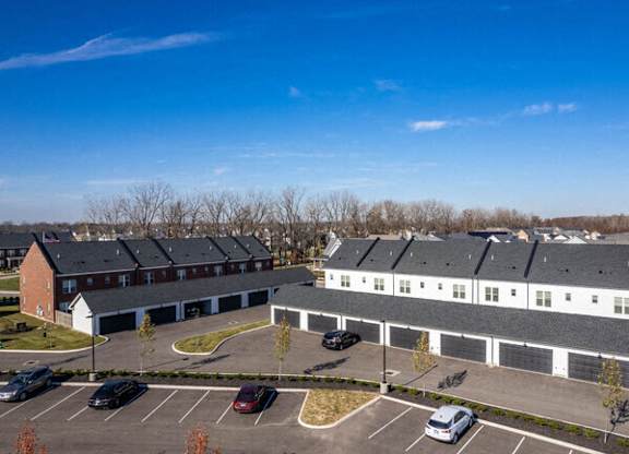 A parking lot with cars and a building in the background.