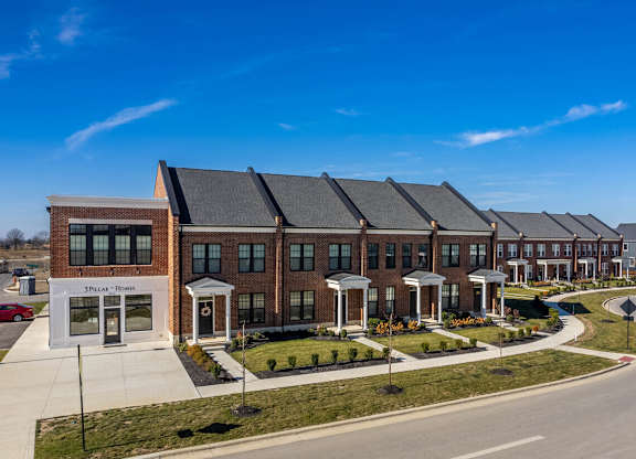 A row of houses with a clear blue sky above them.