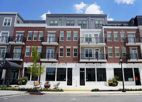 A street view of a multi-story building with the word "COLLECTIVE" on the front.