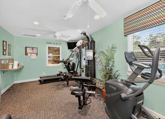 A room with a treadmill, exercise bike, and other equipment at Sawbranch Apartments, Summerville, South Carolina