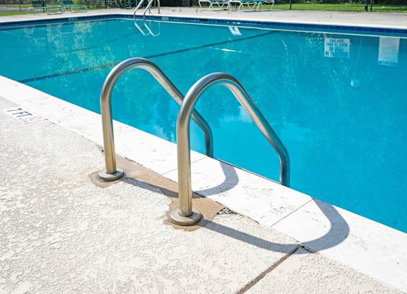 A pool with a metal ladder at Sawbranch Apartments, South Carolina