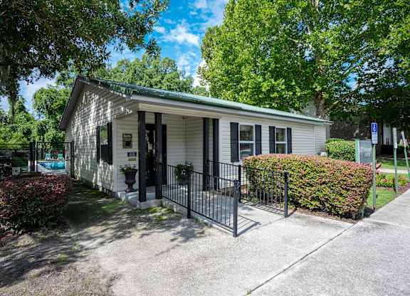 A small house with a black fence in front at Sawbranch Apartments, Summerville, SC