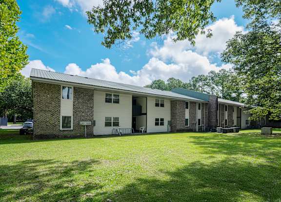 A house with a green lawn in front of it at Sawbranch Apartments, Summerville