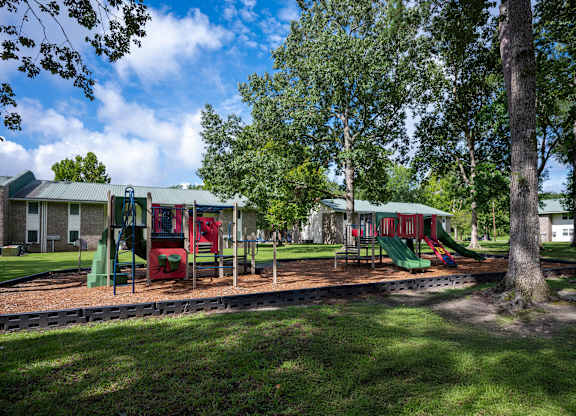 A playground with a red slide and green slide at Sawbranch Apartments, South Carolina