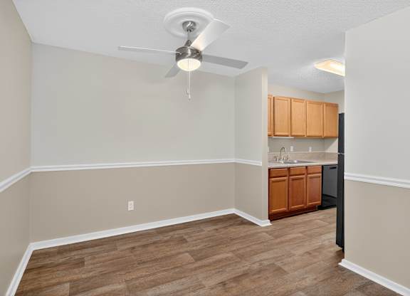 A room with a ceiling fan and wooden flooring at Sawbranch Apartments, Summerville, South Carolina