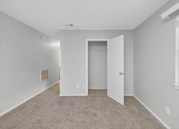 A room with a carpeted floor and a doorway leading to another room at Sawbranch Apartments, Summerville