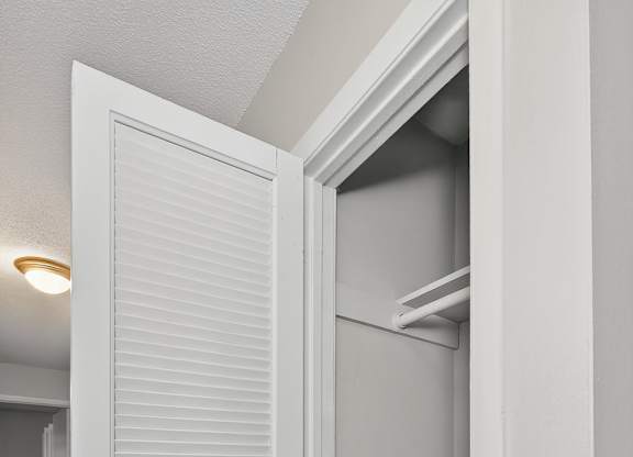 A white door with a silver handle is open at Sawbranch Apartments, Summerville, South Carolina