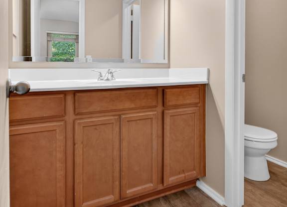 A bathroom with a white countertop and a wooden cabinet at Sawbranch Apartments, Summerville, South Carolina