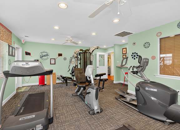 A gym with treadmills, exercise bikes, and other equipment at Woodlocke Apartments, Moncks Corner 27461