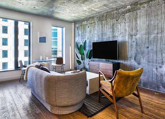 A living room with a couch, chair, and television.at Eleven Fifty Clay Street, Oakland, 94607  