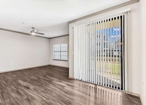 A room with a sliding door and a ceiling fan.at Onyx183, Austin Texas  