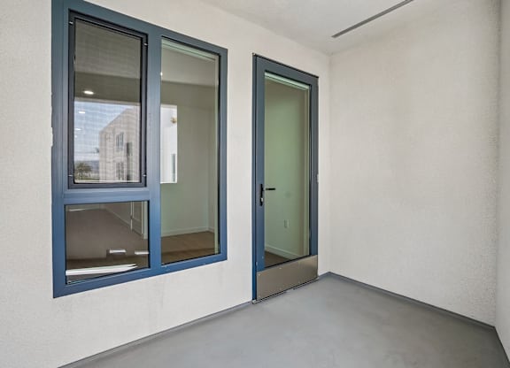 A room with a white wall and a blue window.