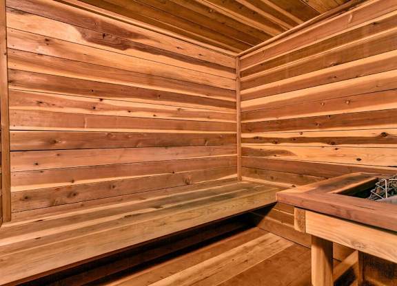 A wooden sauna with a bench and a table. at The Lex At Lowry, Denver, CO