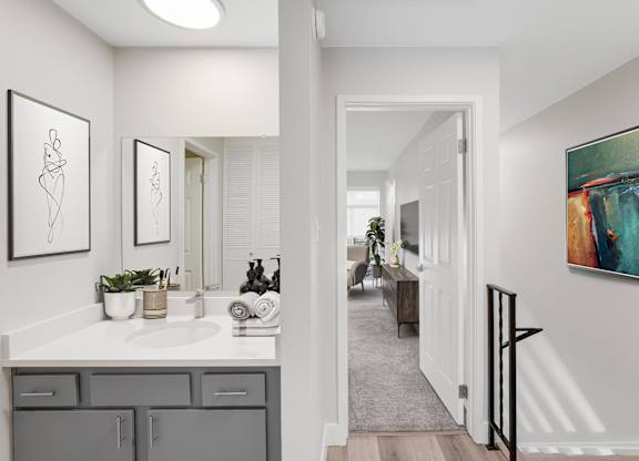 A bathroom with a white countertop and a white sink. at The Lex At Lowry, Denver