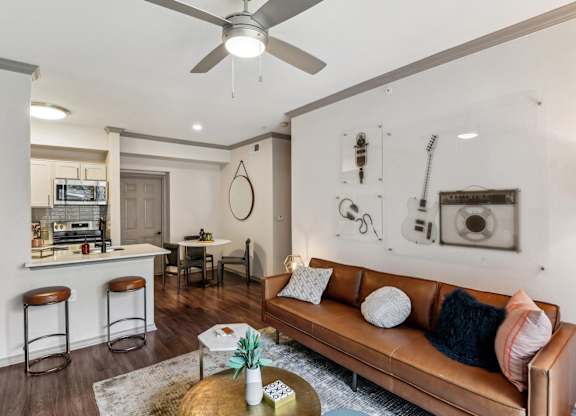 A living room with a brown leather couch and a coffee table in front of it.at Onyx183, Texas  
