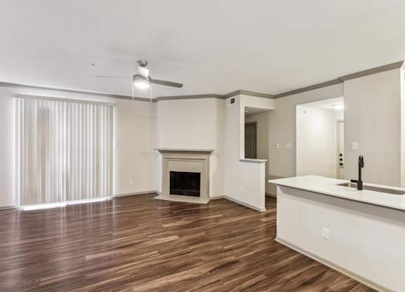 A spacious living room with a fireplace and a bar area.at Onyx183, Austin, 78729  