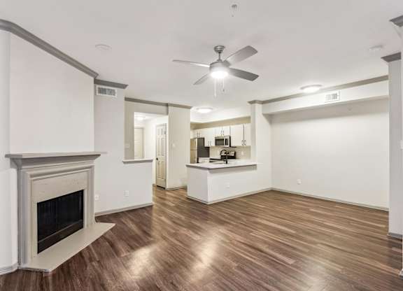 A room with a fireplace and a ceiling fan.at Onyx183, Austin, TX 78729  