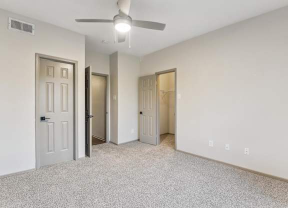 A room with a ceiling fan and three doors.at Onyx183, Texas, 78729