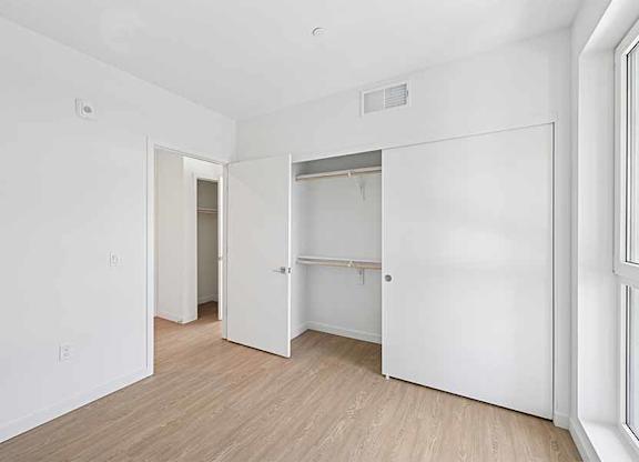 A white room with a doorway leading to another room.