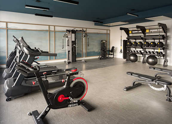 A gym with a stationary bike in the foreground.