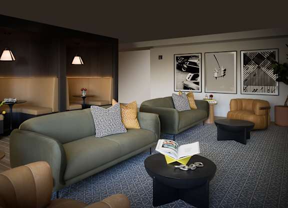 A living room with a green couch and a coffee table.