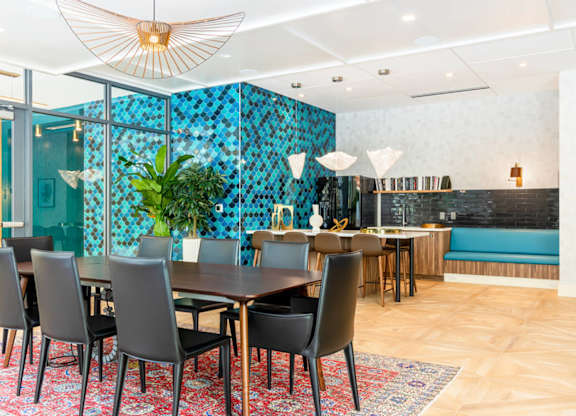 A dining room with a table set for six with chairs around it.at The Vale at the Parks, Washington  