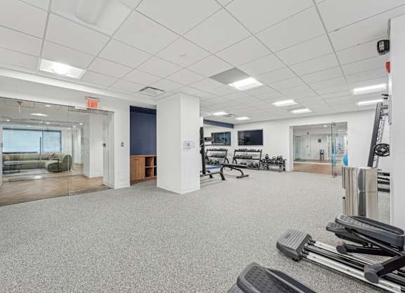 A gym with a variety of equipment including treadmills, weights and exercise machines at Sherwood at Southern Towers, Alexandria, 22311