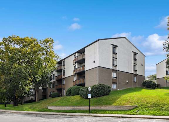 Apartment building with a tree in front of it.