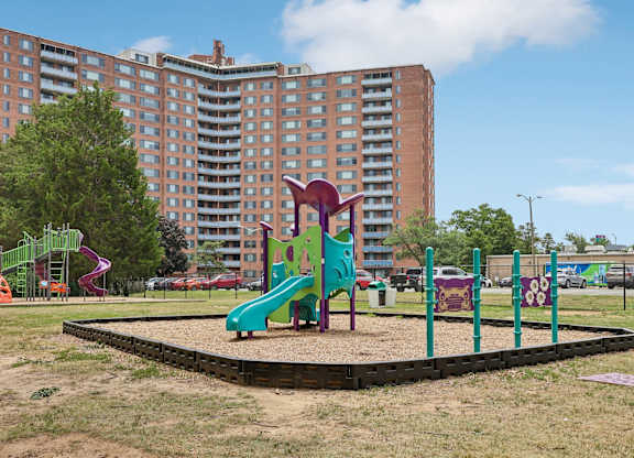 A playground with a purple slide and a green slide.
