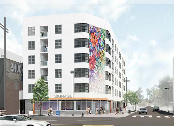 A white building with a colorful mural on the side.