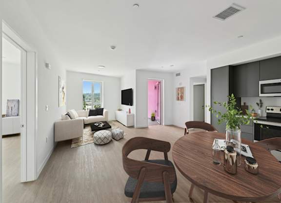 A modern living room with a brown wooden table and chairs.