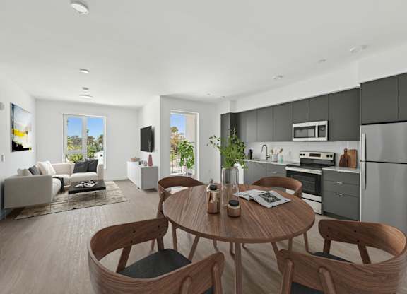 A modern kitchen with a dining table and chairs.