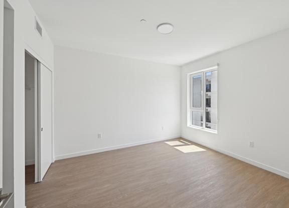 A room with a window and a door.
