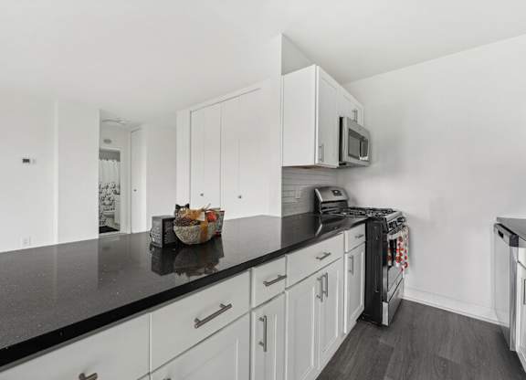 A Kitchen With a Black Countertop at Ashlawn at Southern Towers, Virginia