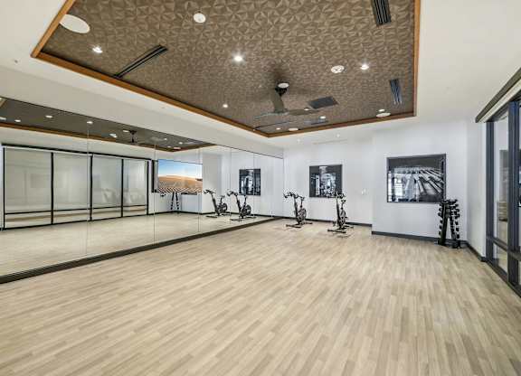 Fitness center with yoga and stretching area at Bayview Apartments, Emeryville, California, 94608