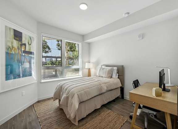 Bedroom with a desk and chair at Bayview Apartments, Emeryville