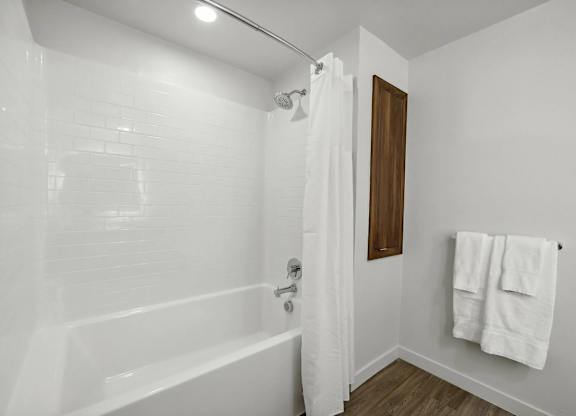Bathroom with shower and curtain at Bayview Apartments, Emeryville, 94608