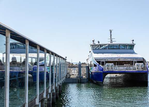 A large white boat is docked at a pier.at Channel House, Oakland, CA